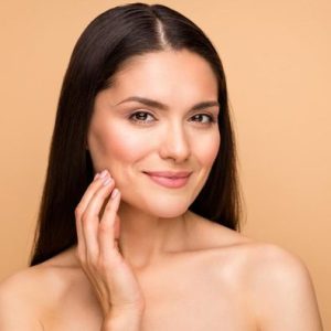 woman with nice skin touching face with hand